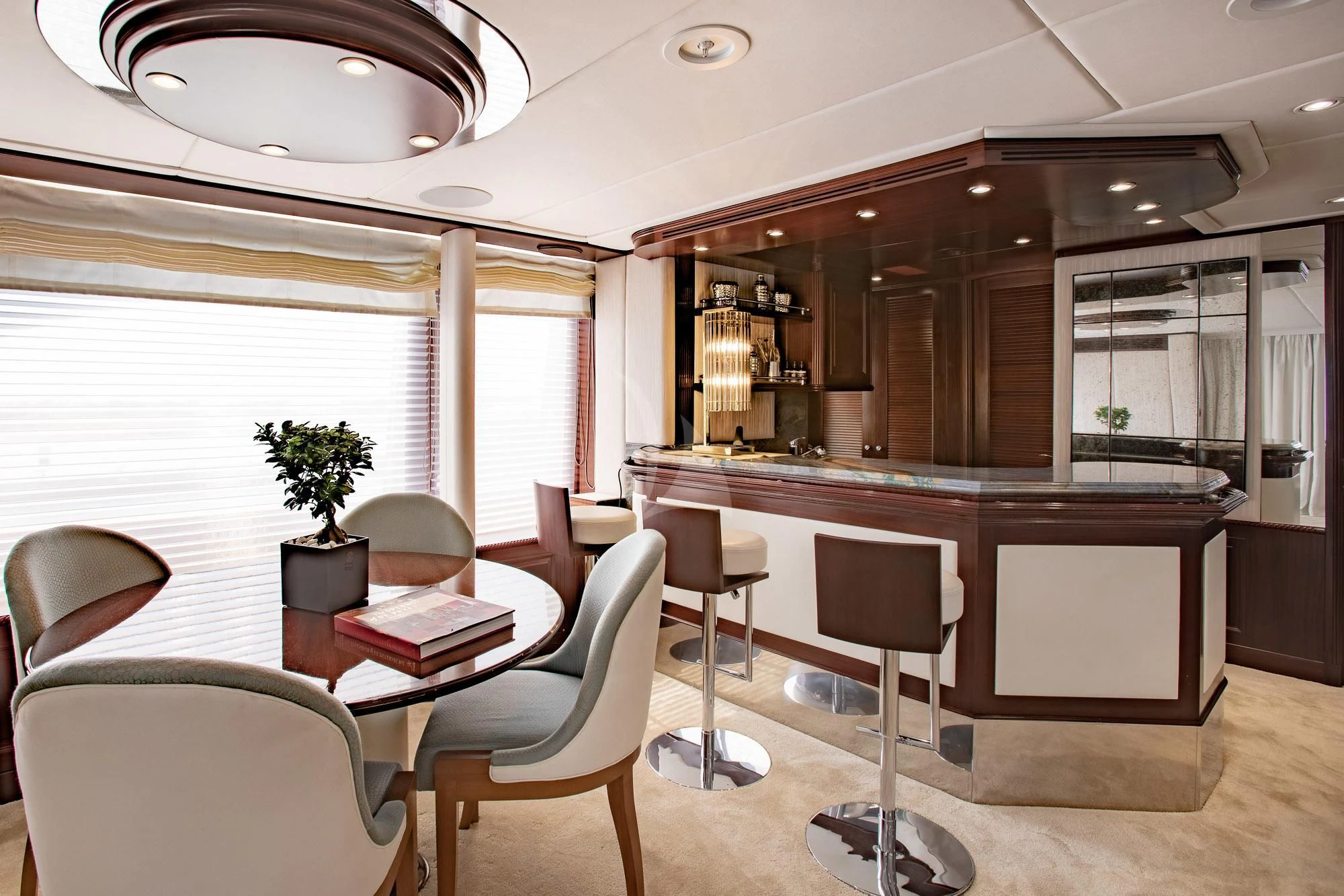 a large kitchen with a dining table aboard AKIRA ONE Yacht for Charter
