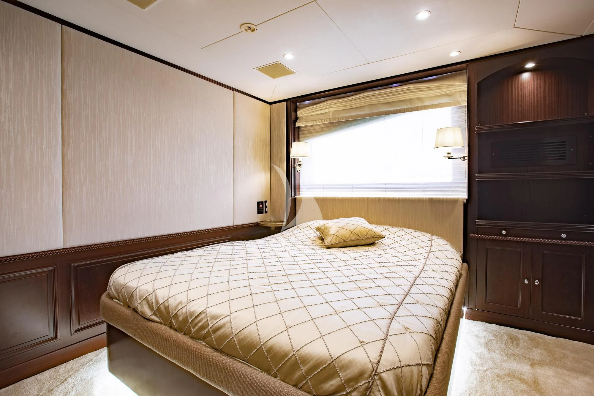 a bedroom with a bed and a dresser aboard AKIRA ONE Yacht for Charter