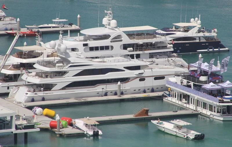 a large white yacht docked at a pier aboard AKIRA ONE Yacht for Charter