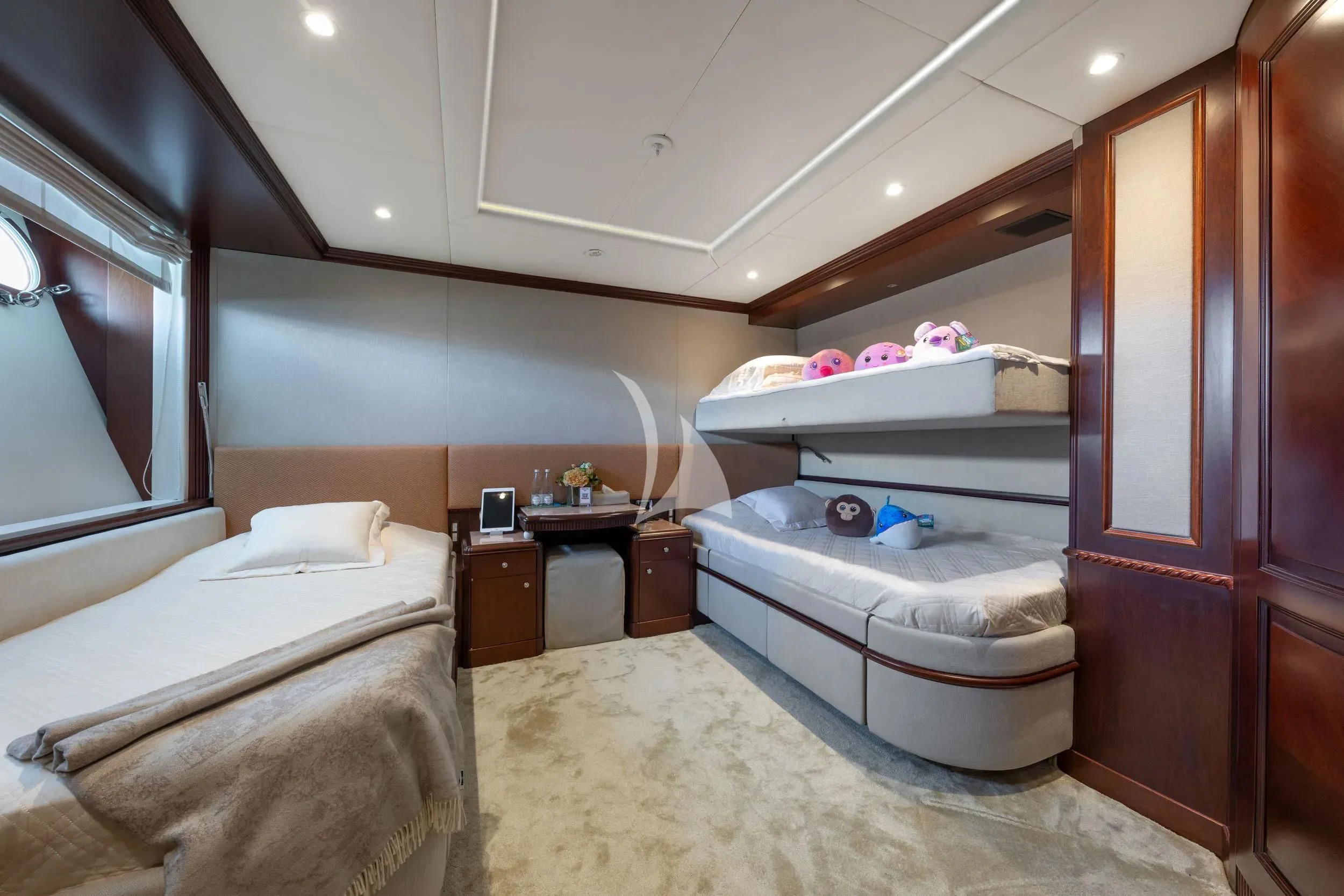 a bedroom with a bed and a dresser aboard AKIRA ONE Yacht for Charter