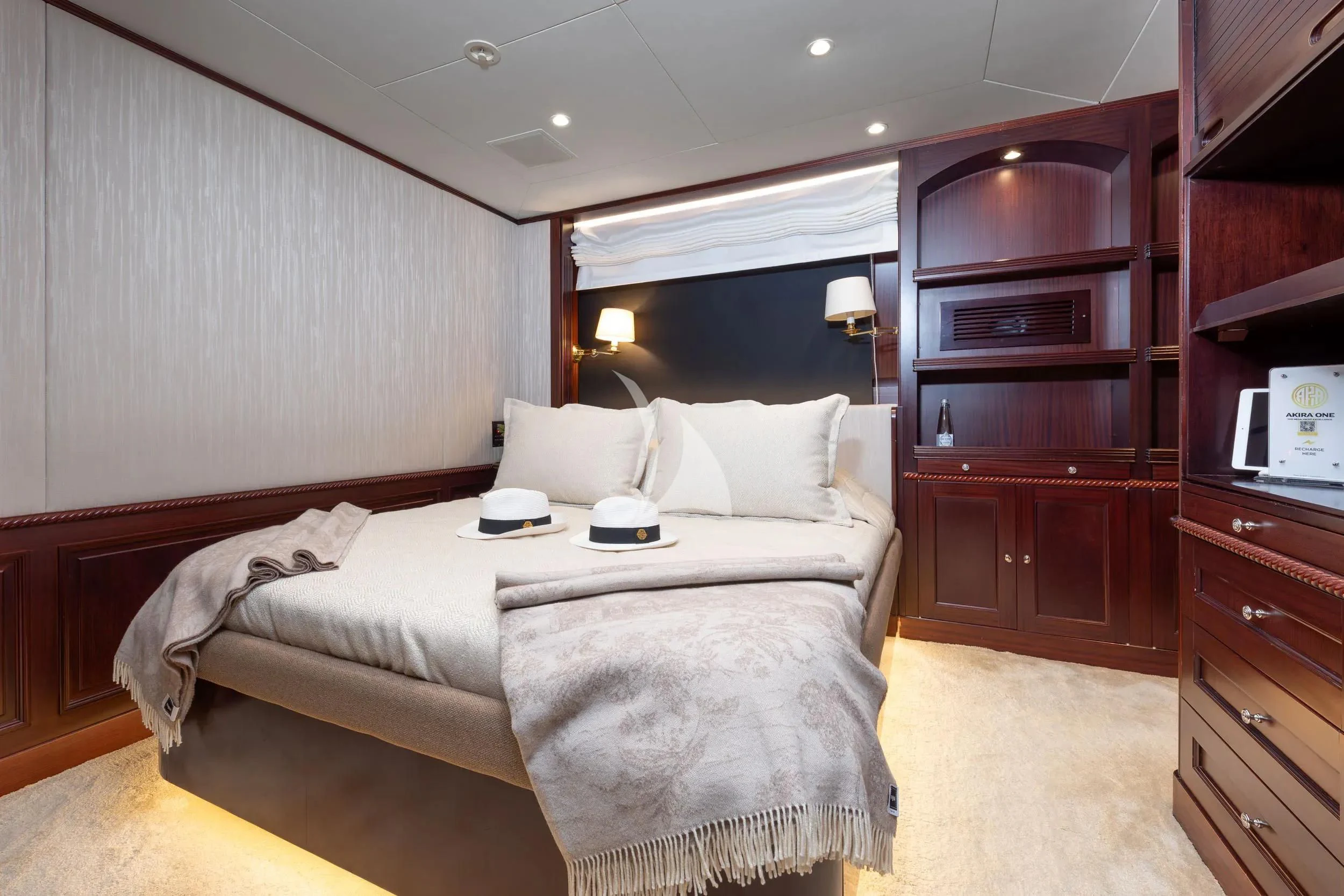 a bedroom with a bed and a tv aboard AKIRA ONE Yacht for Charter