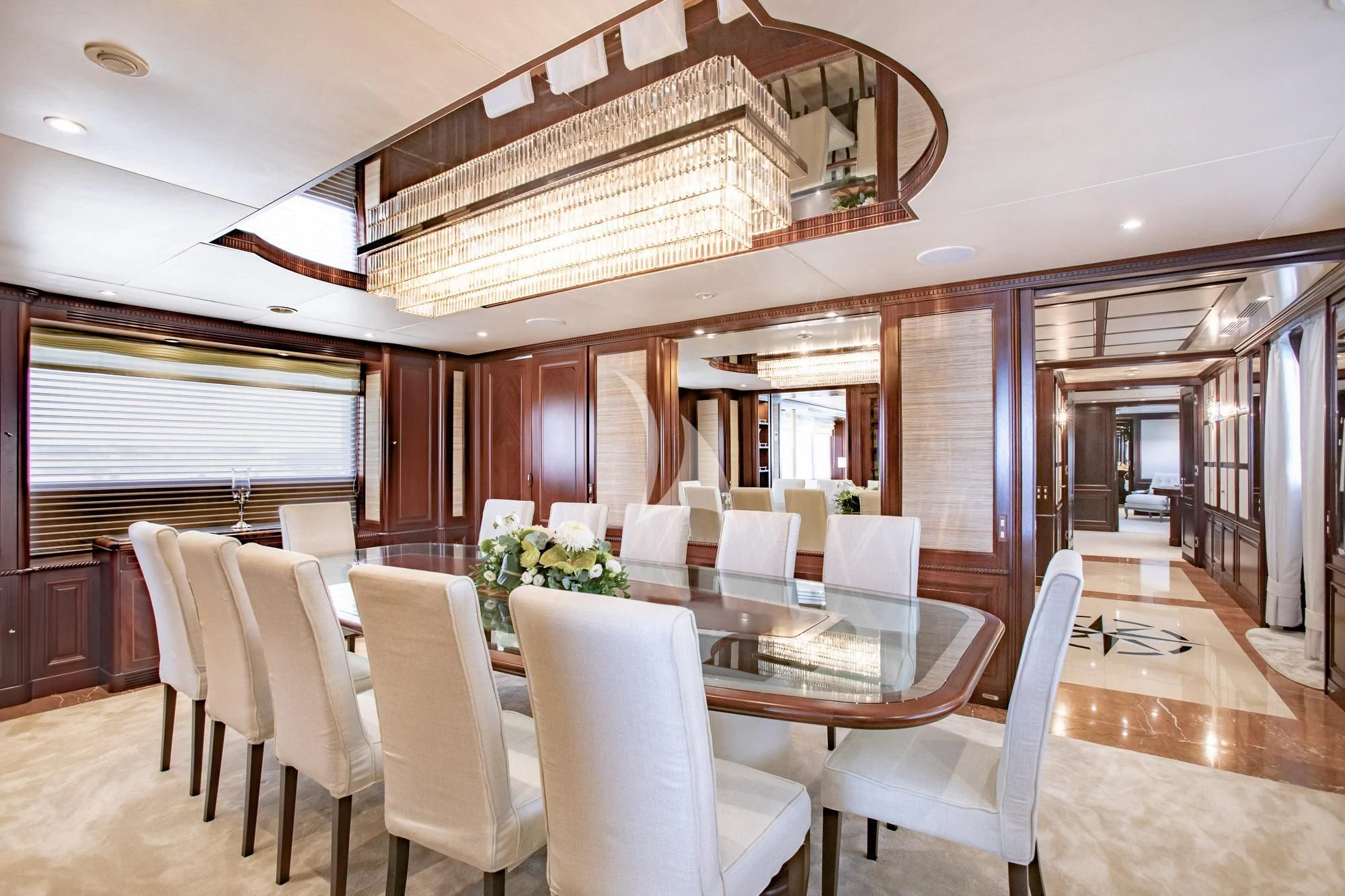 a dining room with a chandelier aboard AKIRA ONE Yacht for Charter