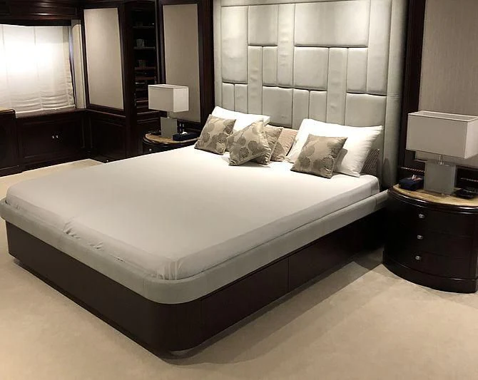 a bed with white sheets aboard AKIRA ONE Yacht for Charter