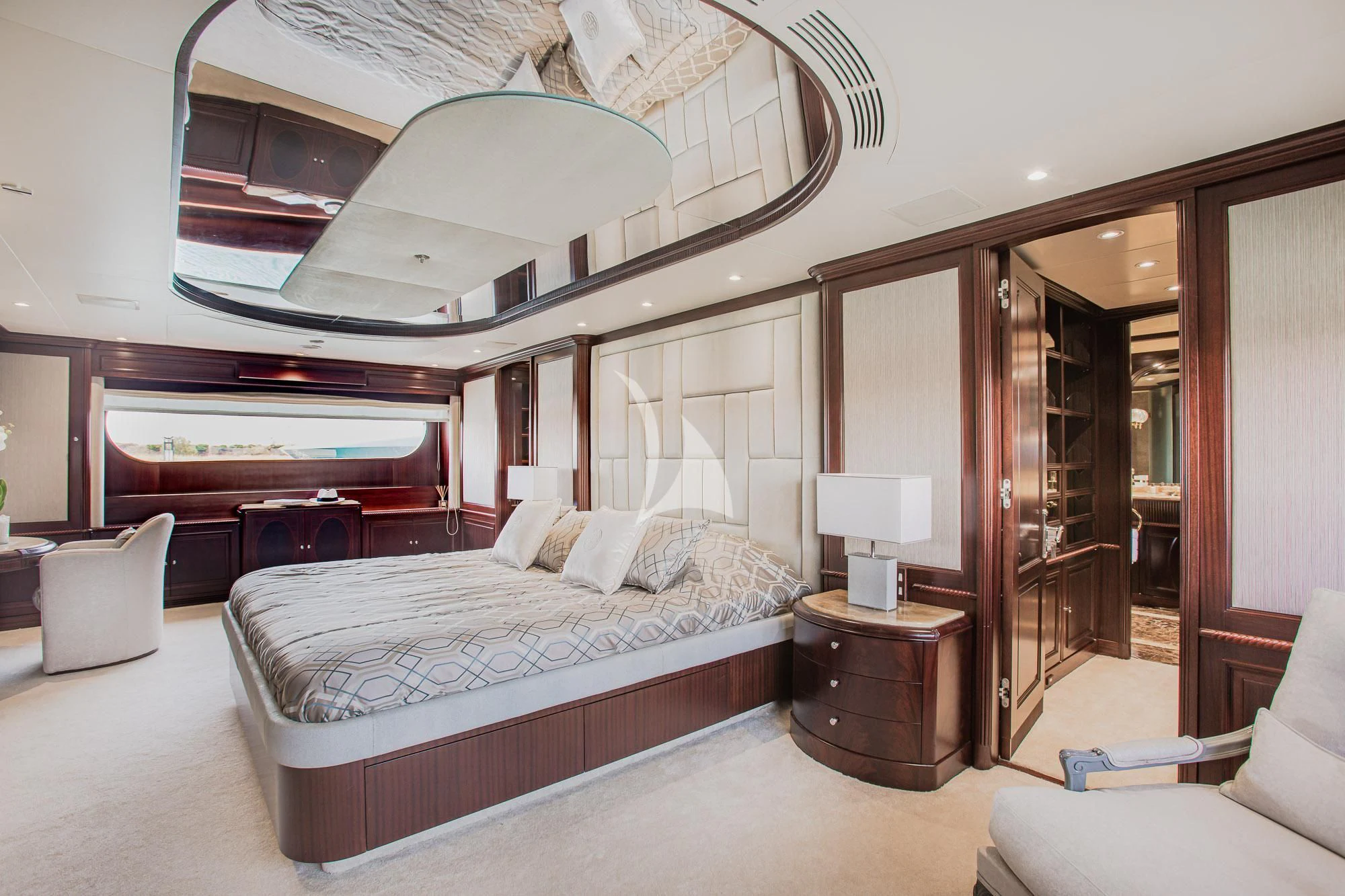 a bedroom with a bed and a mirror aboard AKIRA ONE Yacht for Charter