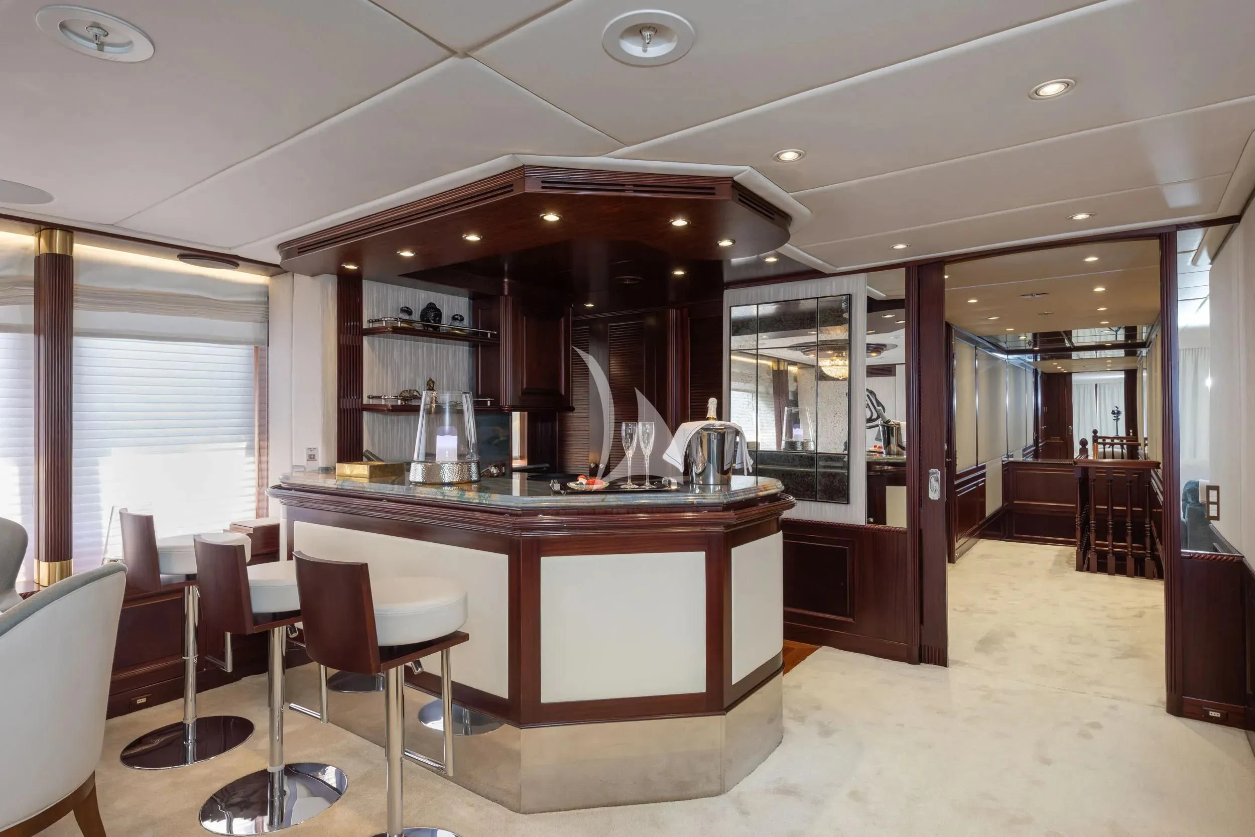 a kitchen with a bar and chairs aboard AKIRA ONE Yacht for Charter