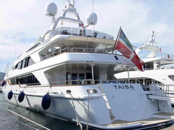 a large white boat with flags aboard AKIRA ONE Yacht for Charter