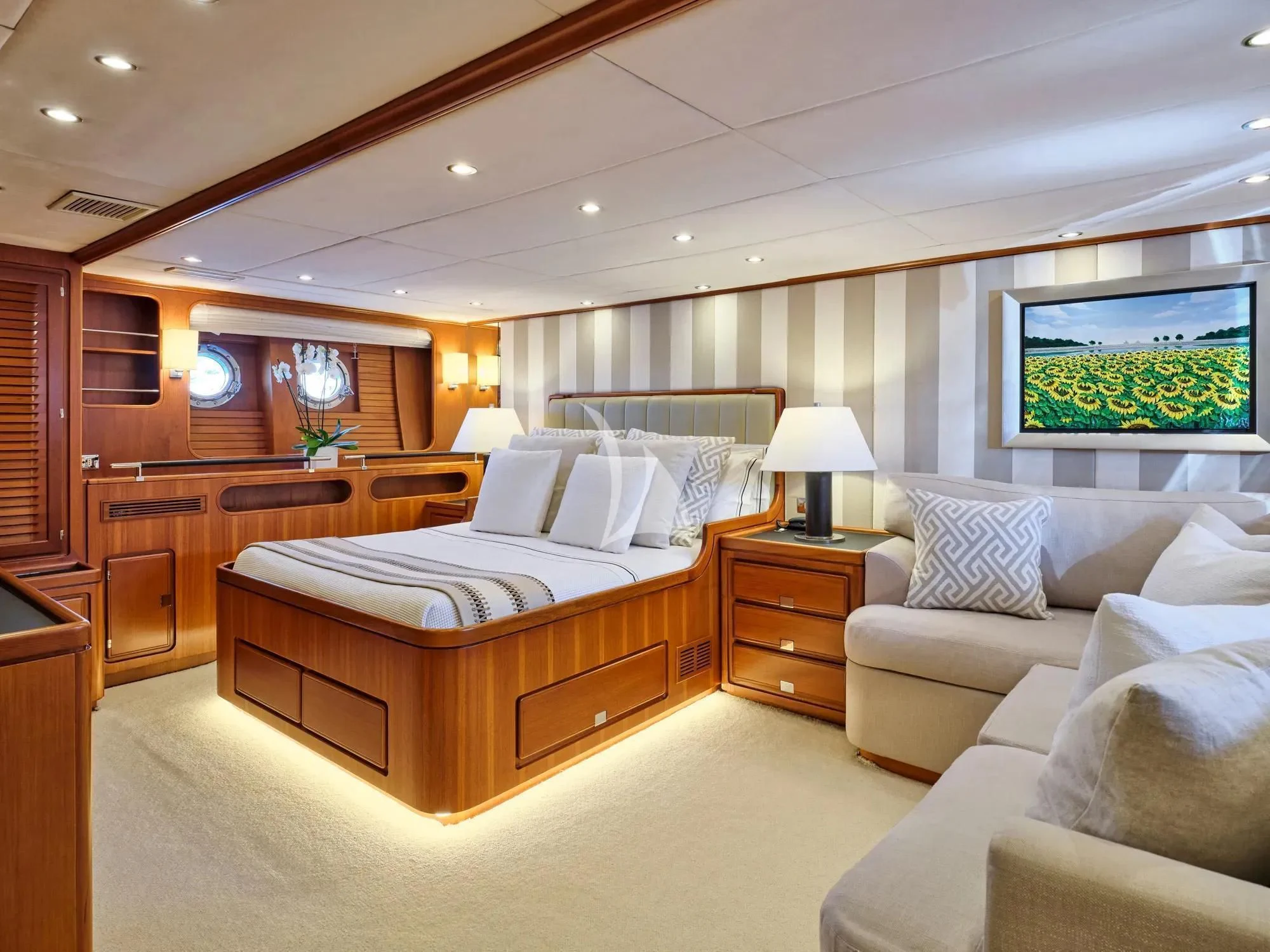 a bedroom with a bed and a couch aboard GITANA Yacht for Charter