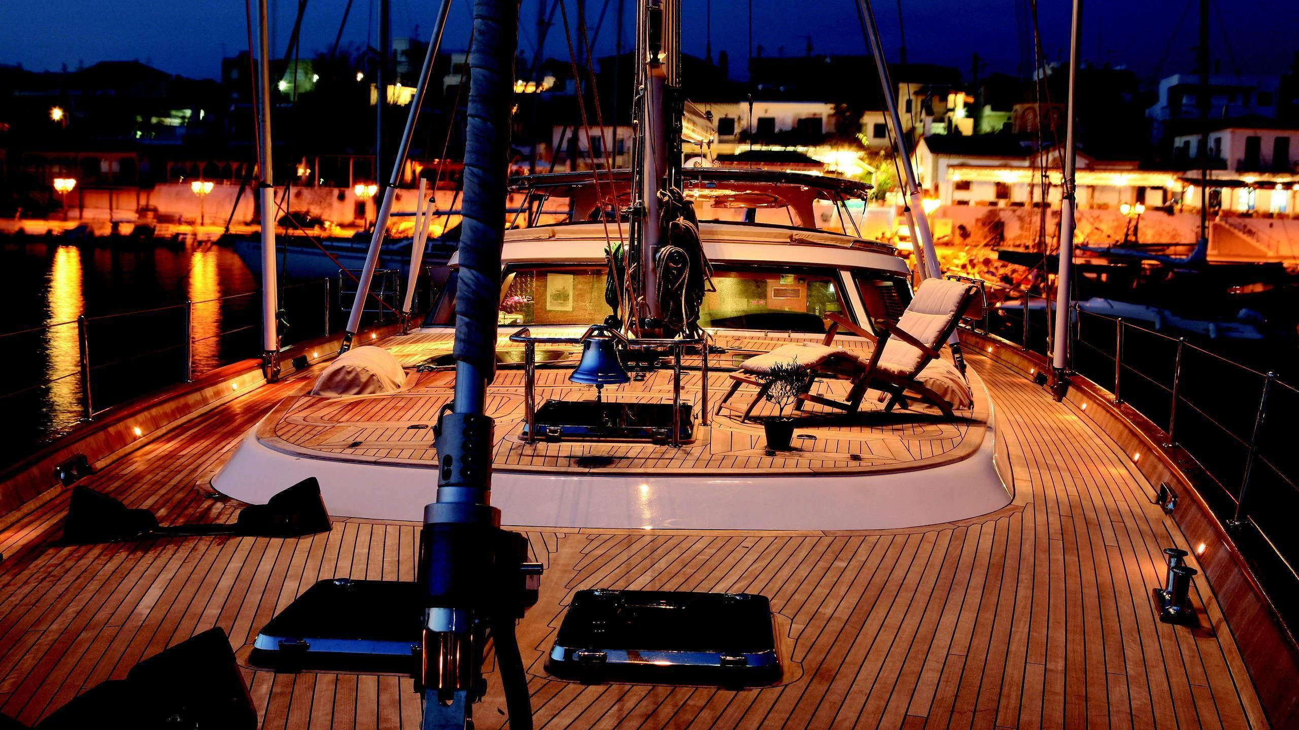 a deck with a boat and a laptop on it aboard GITANA Yacht for Charter