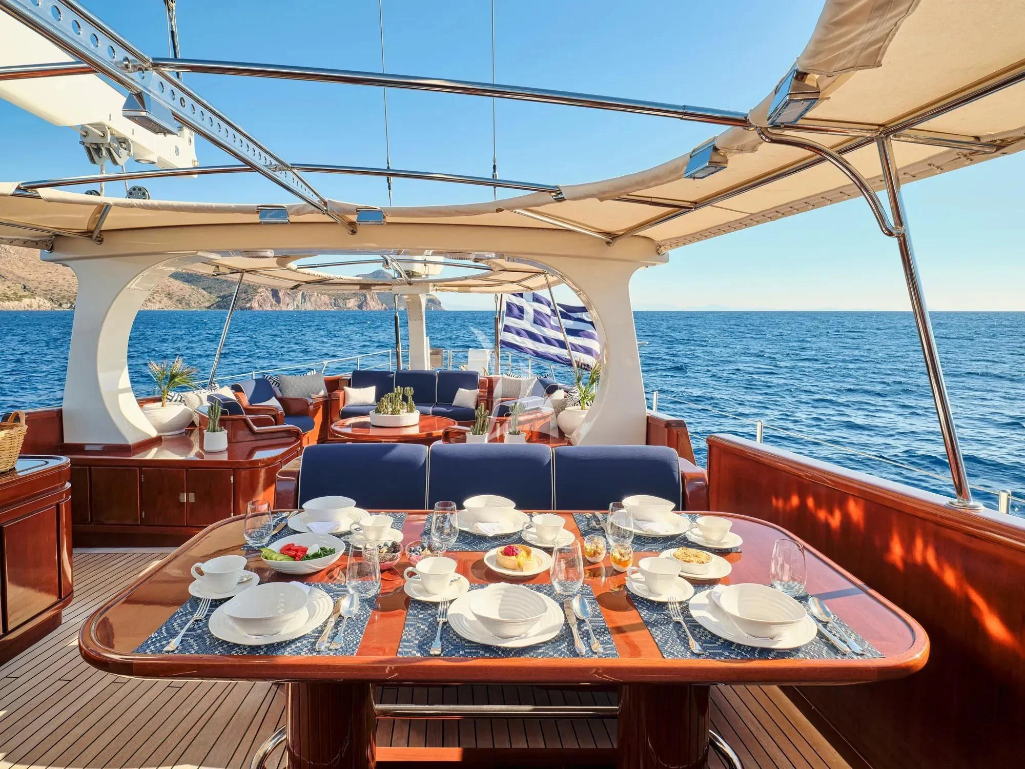 a table set for a meal on a boat aboard GITANA Yacht for Charter