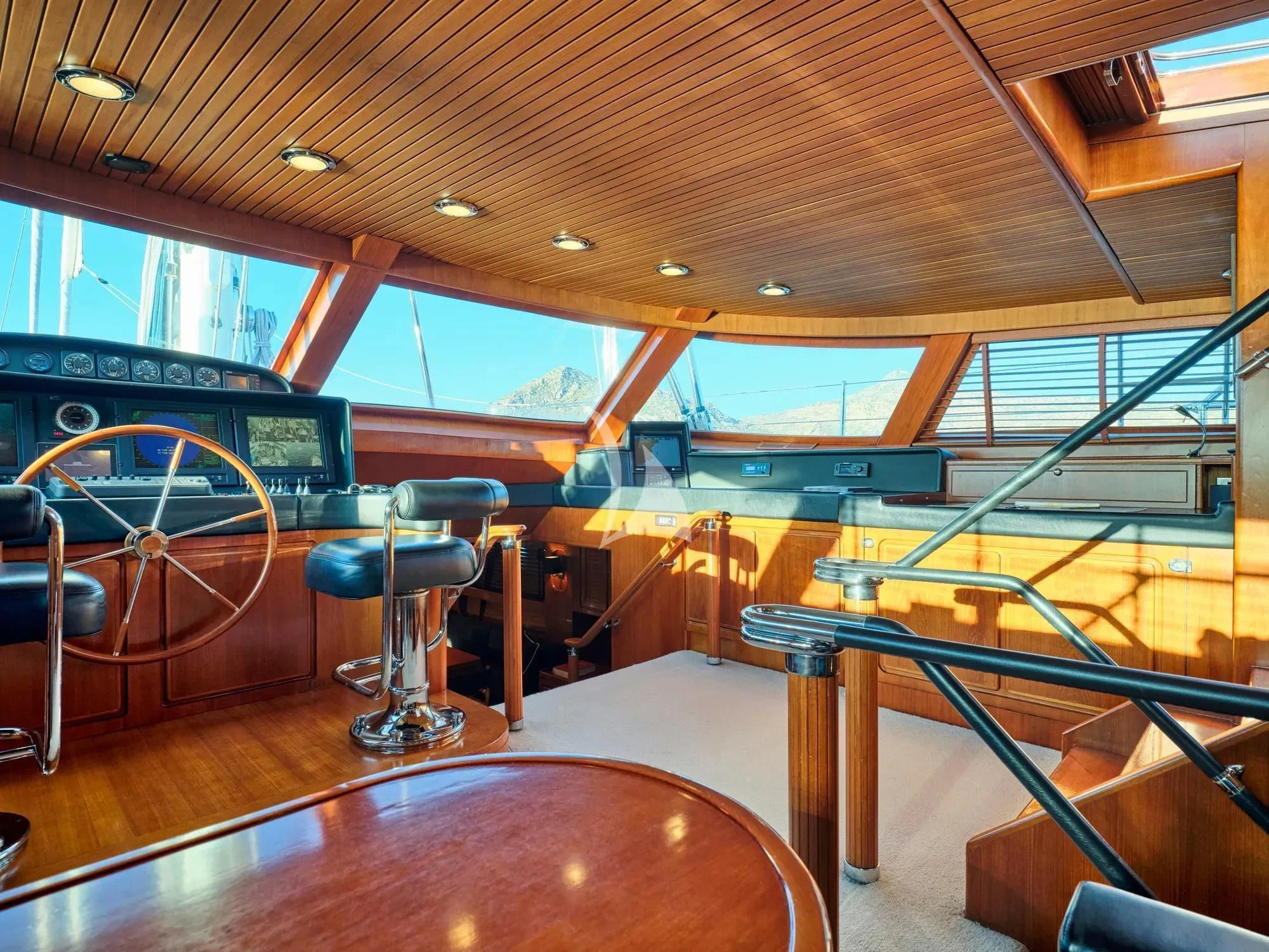 inside of a building with a large escalator and a large table aboard GITANA Yacht for Charter