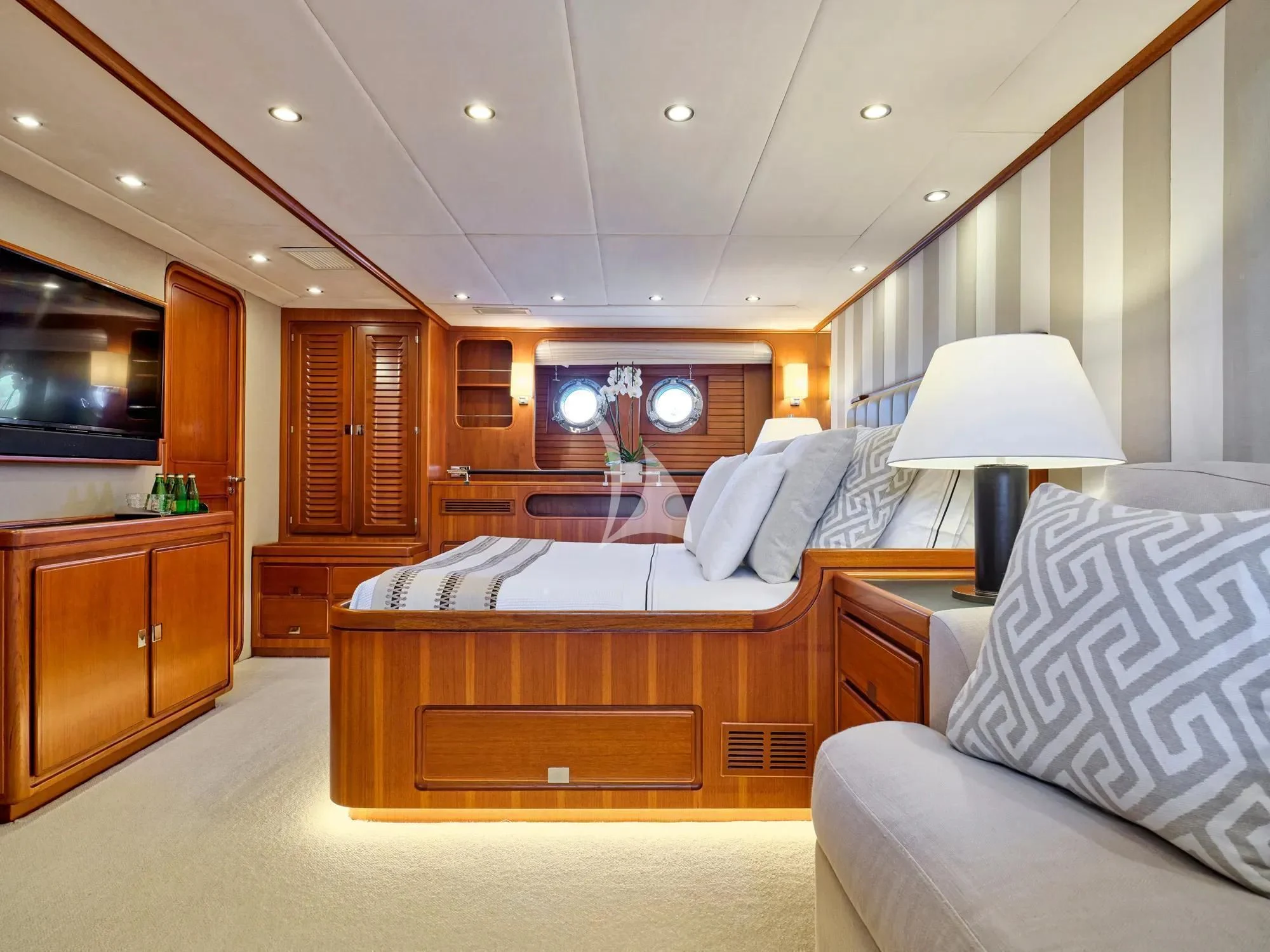 a bedroom with a bed and a couch aboard GITANA Yacht for Charter