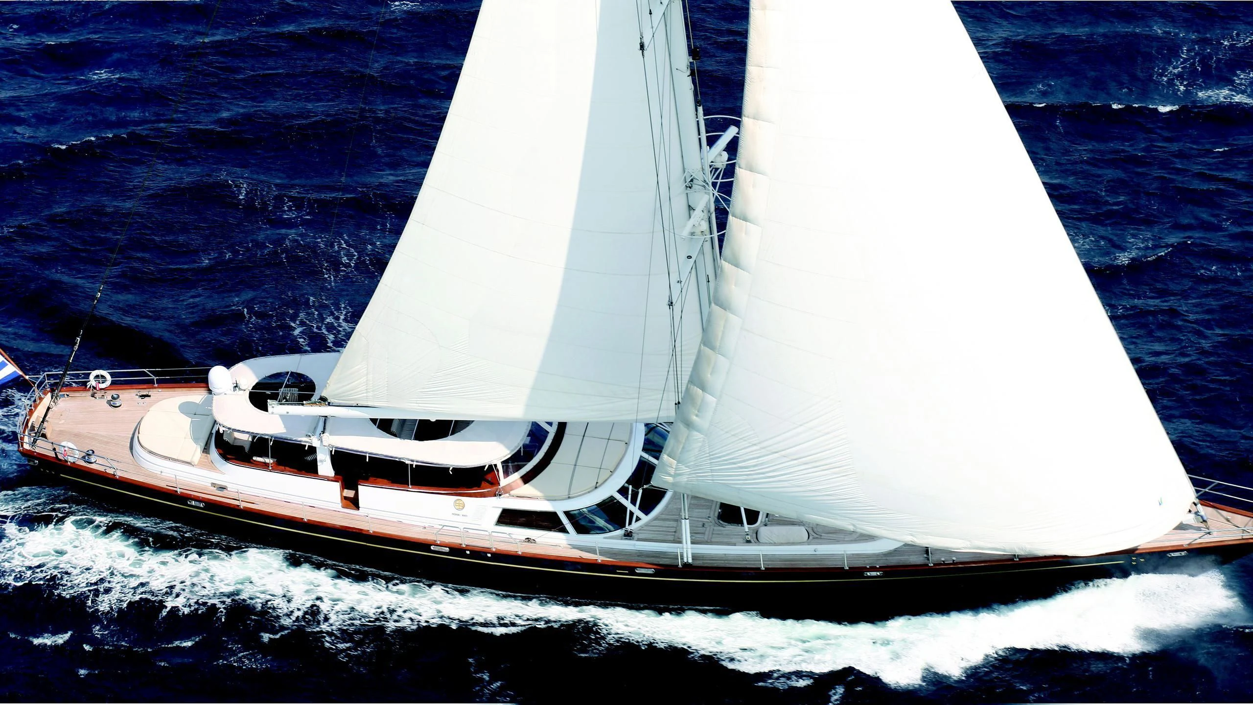 a white sailboat on the water aboard GITANA Yacht for Charter