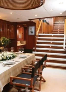 a dining room with a staircase aboard GITANA Yacht for Charter