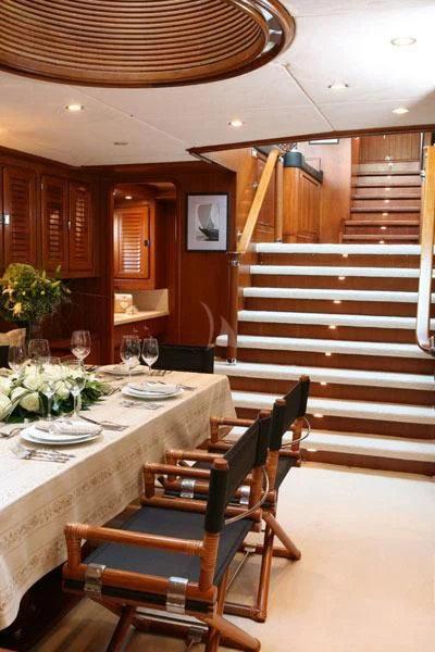 a dining room with a staircase aboard GITANA Yacht for Charter