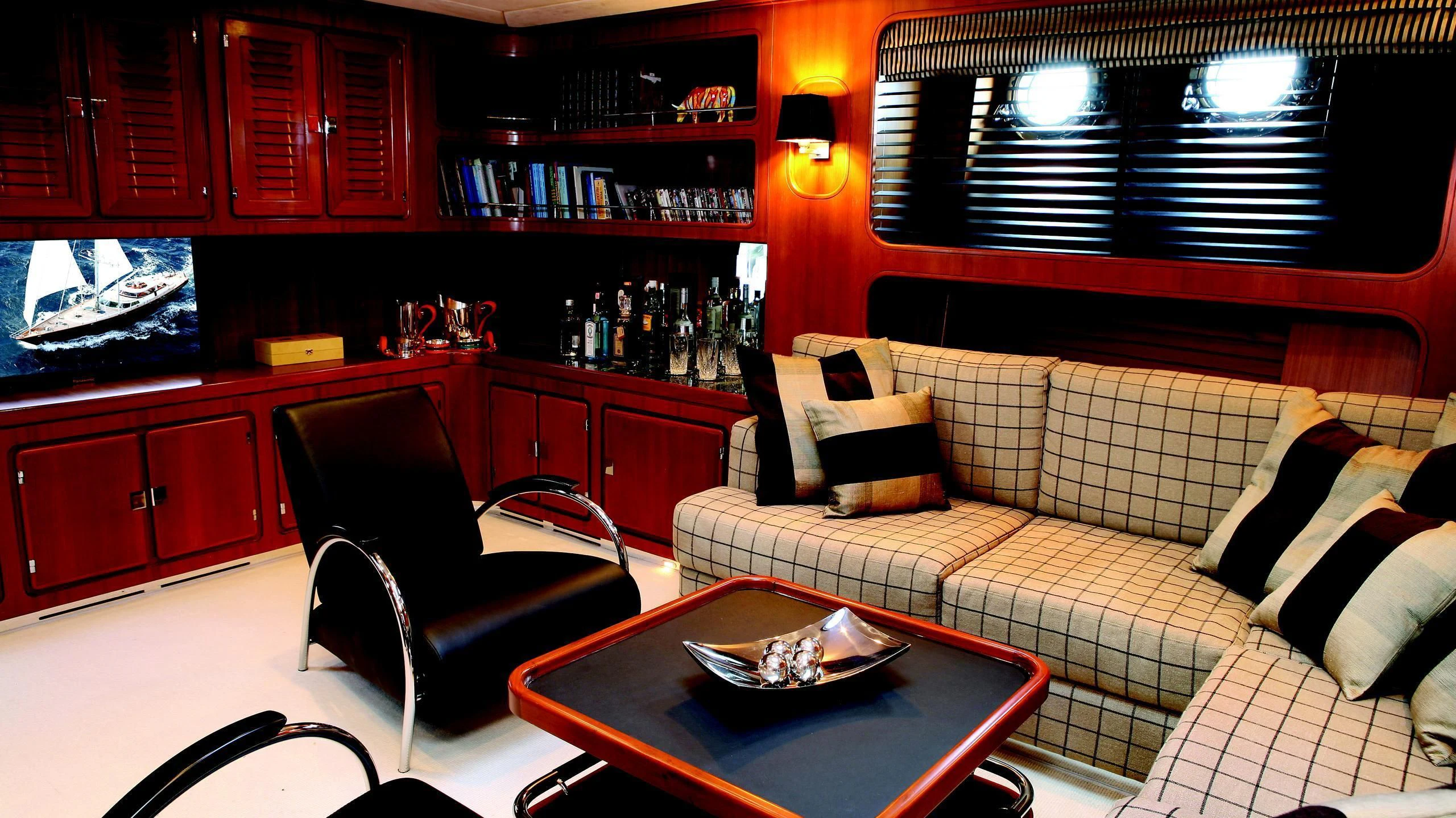a living room with a couch and a coffee table aboard GITANA Yacht for Charter