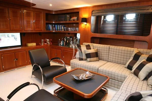 a living room with a couch and a tv aboard GITANA Yacht for Charter