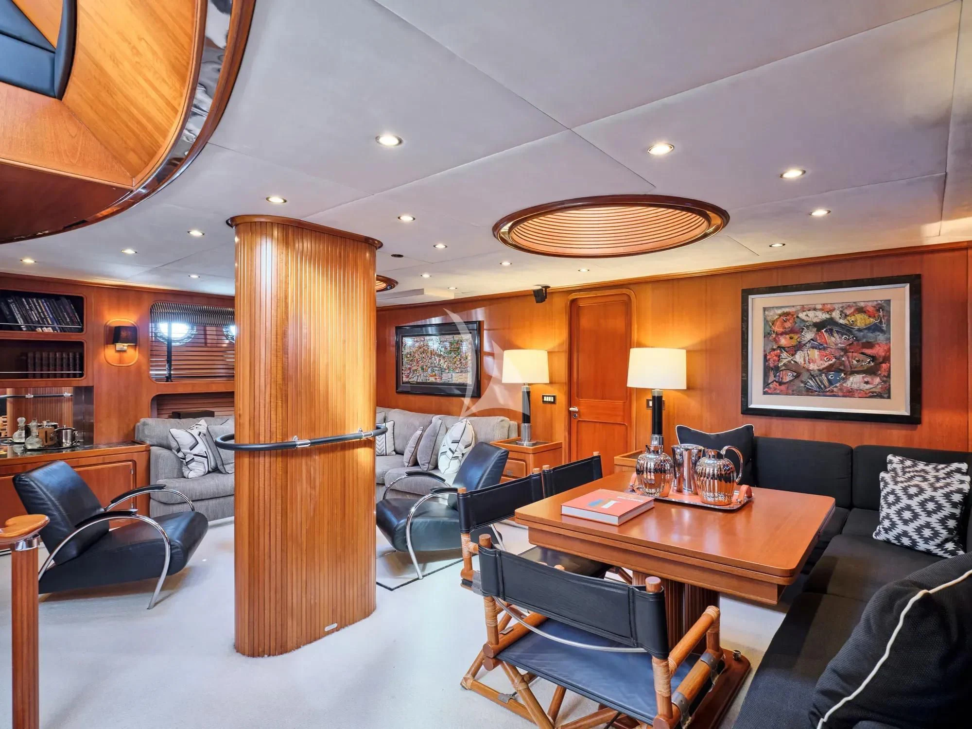 a living room with a large wood table and a large wood window aboard GITANA Yacht for Charter