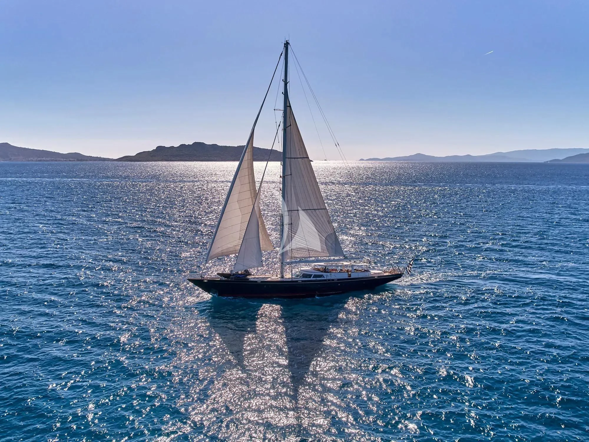 a sailboat in the water aboard GITANA Yacht for Charter