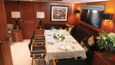 a dining table in a room aboard GITANA Yacht for Charter