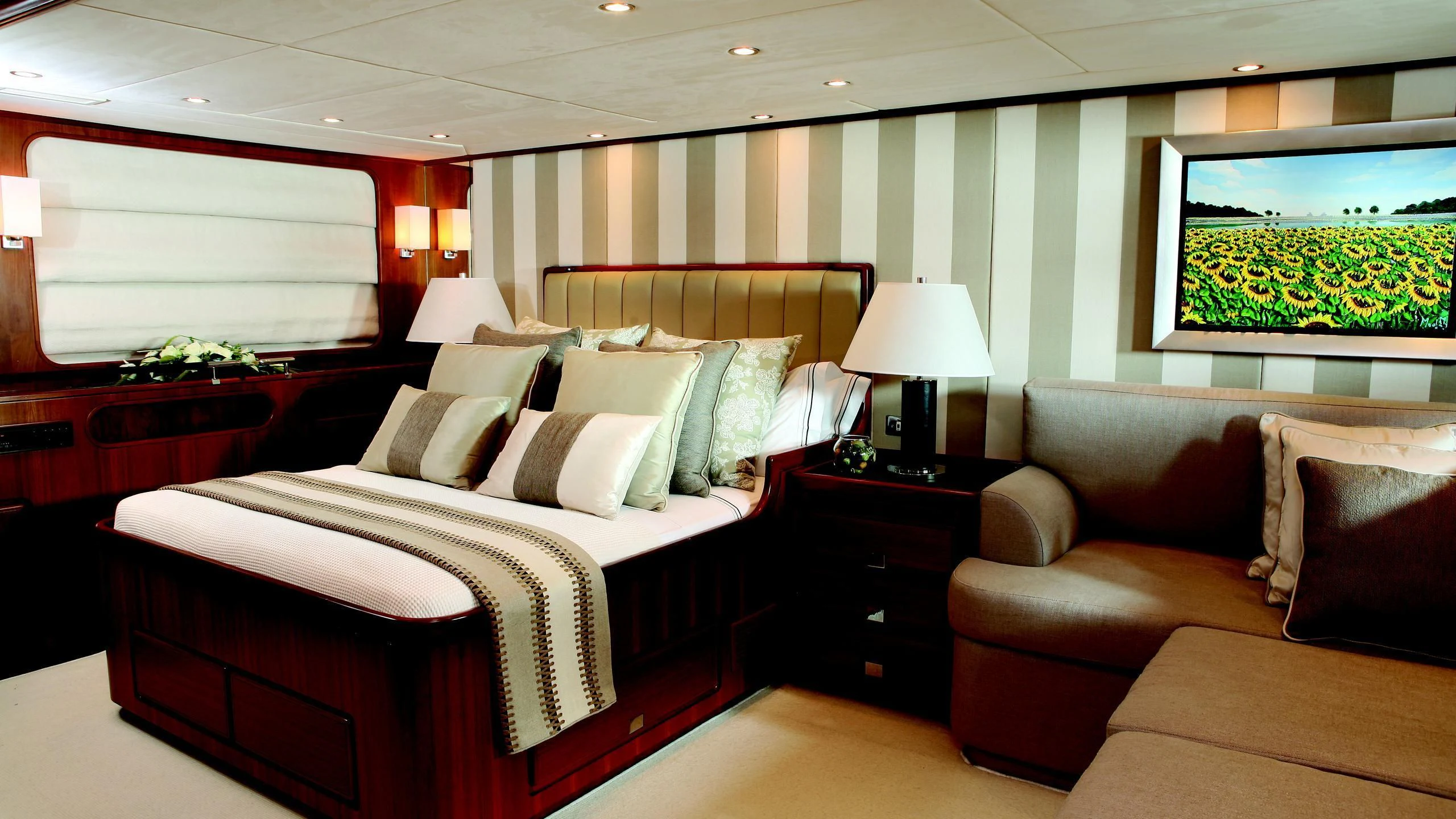 a bedroom with a bed and a couch aboard GITANA Yacht for Charter