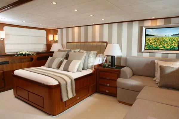 a bedroom with a bed and a couch aboard GITANA Yacht for Charter