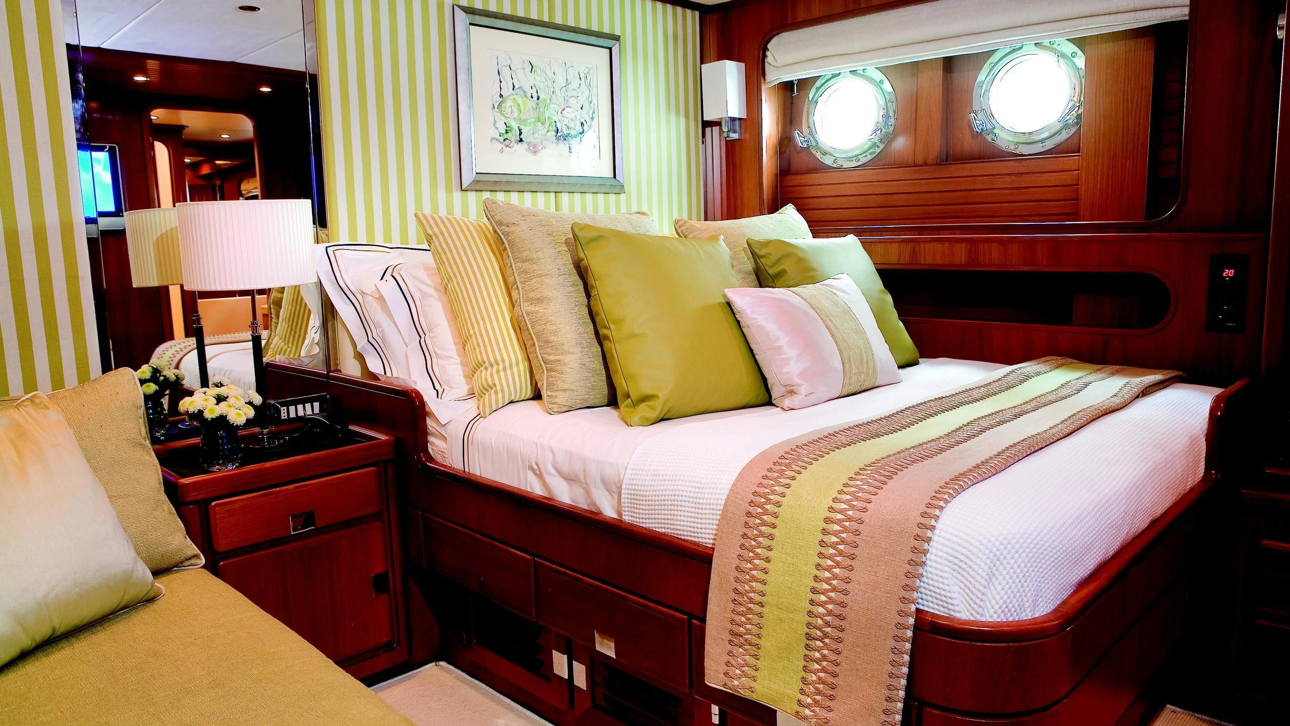 a bed with a white comforter aboard GITANA Yacht for Charter