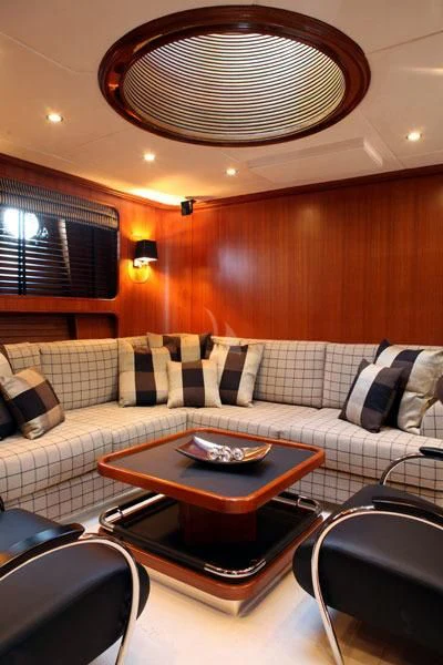 a living room with a couch and a table aboard GITANA Yacht for Charter