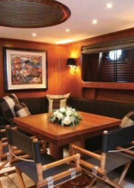 a room with a table and chairs aboard GITANA Yacht for Charter