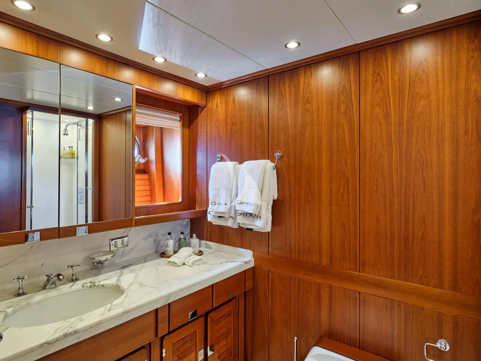 a bathroom with wooden cabinets aboard GITANA Yacht for Charter