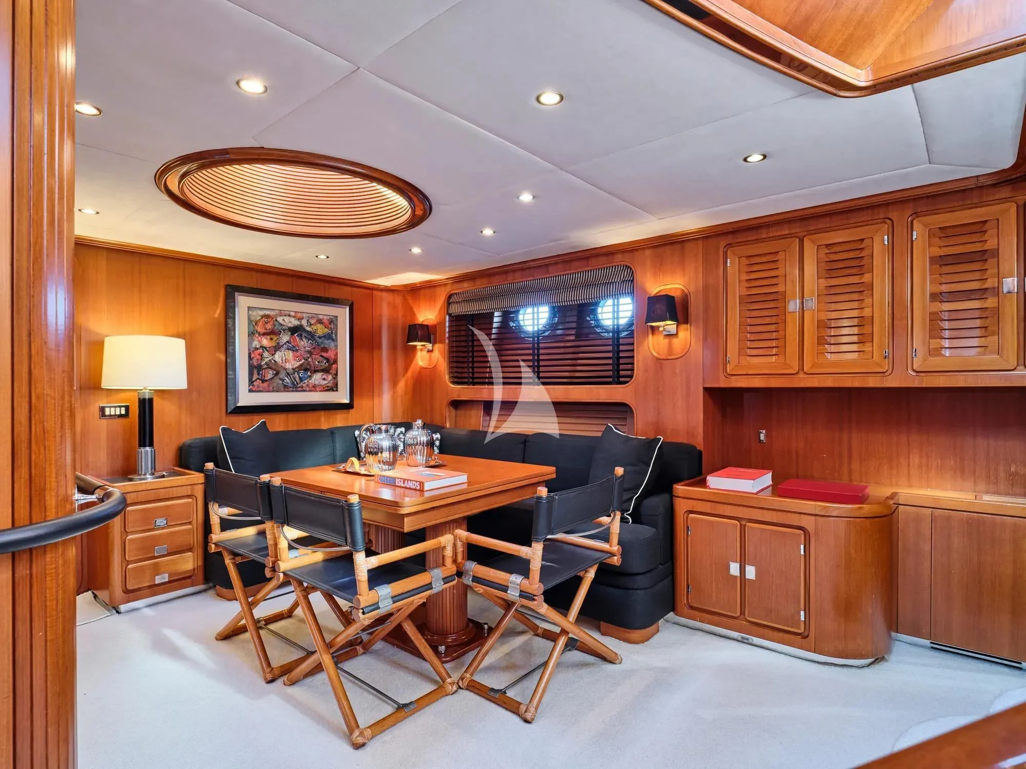 a living room with a dining table aboard GITANA Yacht for Charter