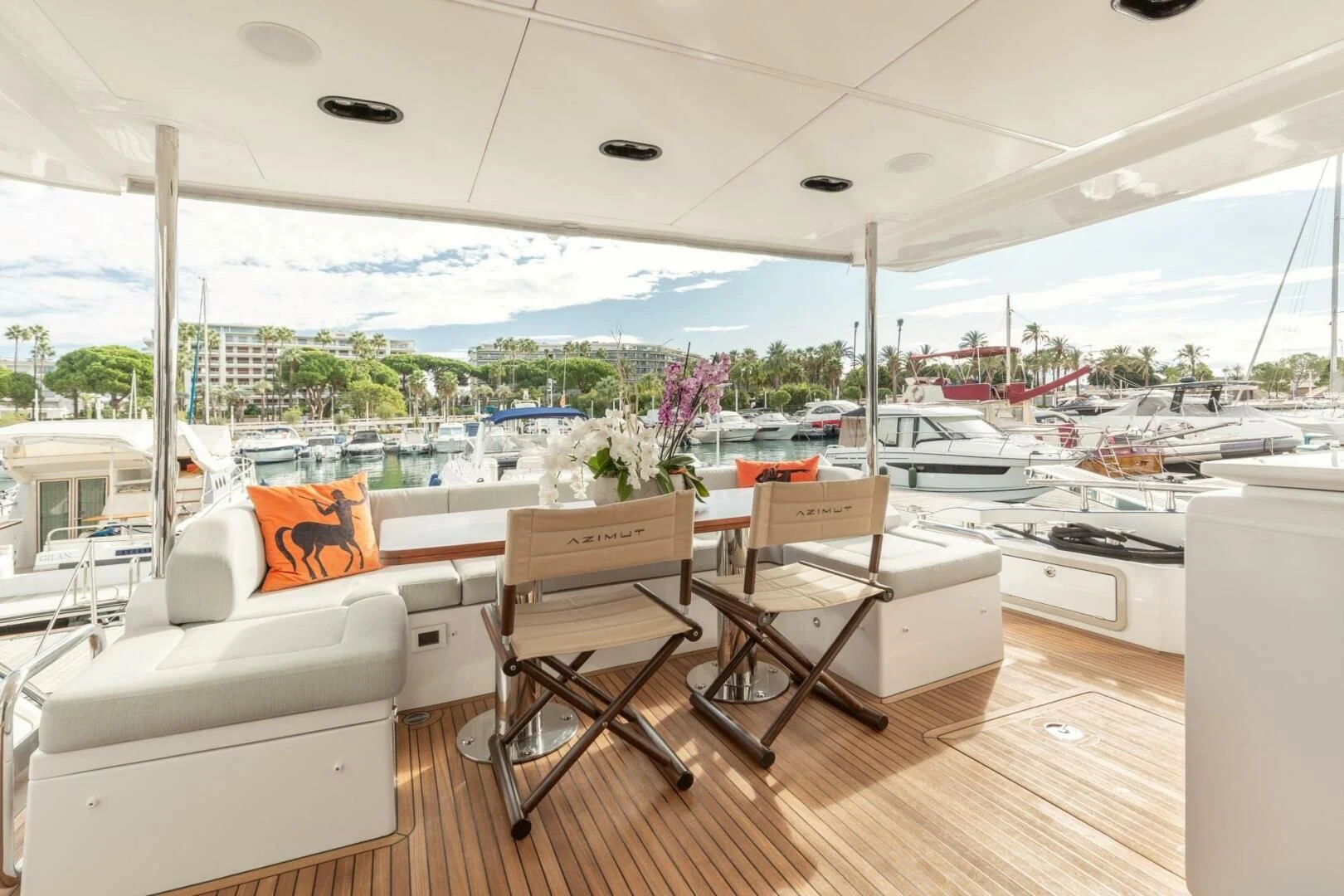a room with a table chairs and a window with a view of the city aboard AZIMUT 72 Yacht for Sale