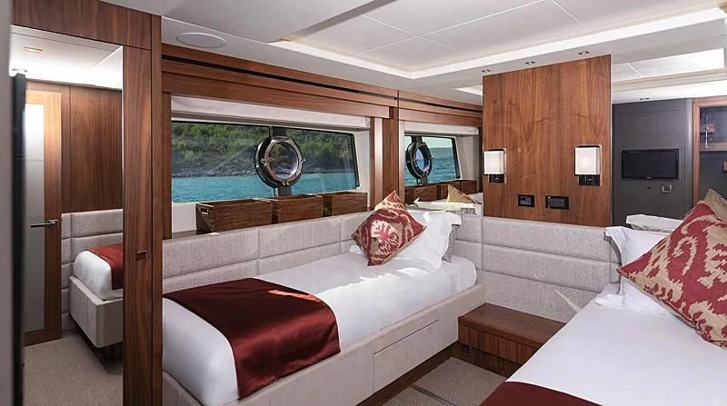 a room with a bed and a television aboard HUNKY DORY OF LONDON Yacht for Sale