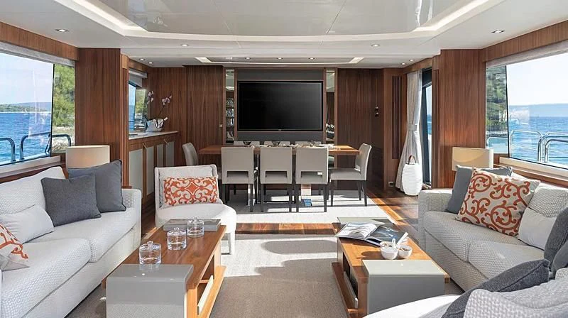 a living room with a tv and furniture aboard HUNKY DORY OF LONDON Yacht for Sale