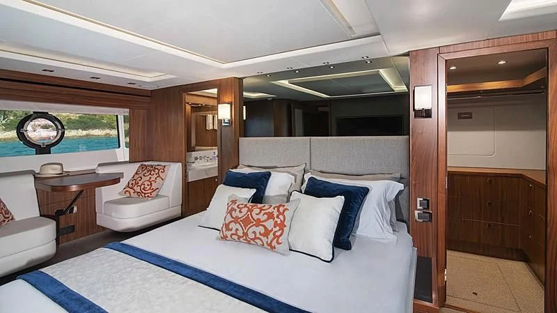 a room with a bed and a chair aboard HUNKY DORY OF LONDON Yacht for Sale