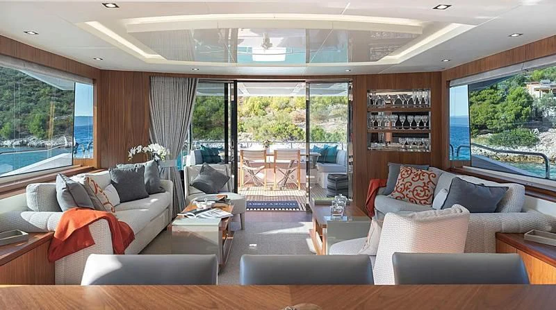 a living room with a large window aboard HUNKY DORY OF LONDON Yacht for Sale
