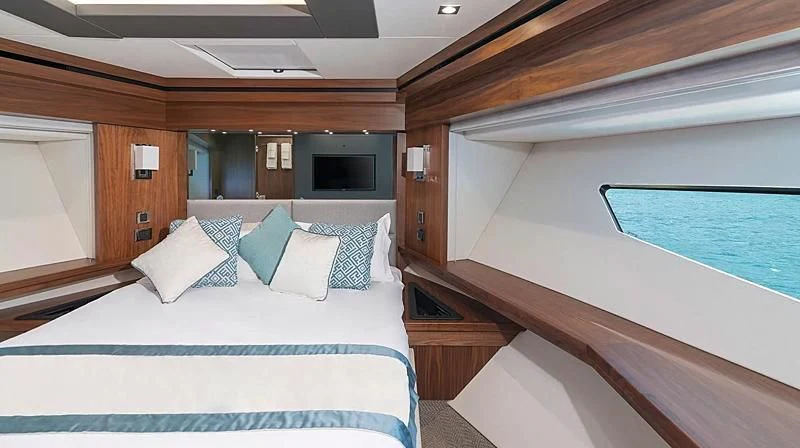 a room with a bed and a television aboard HUNKY DORY OF LONDON Yacht for Sale