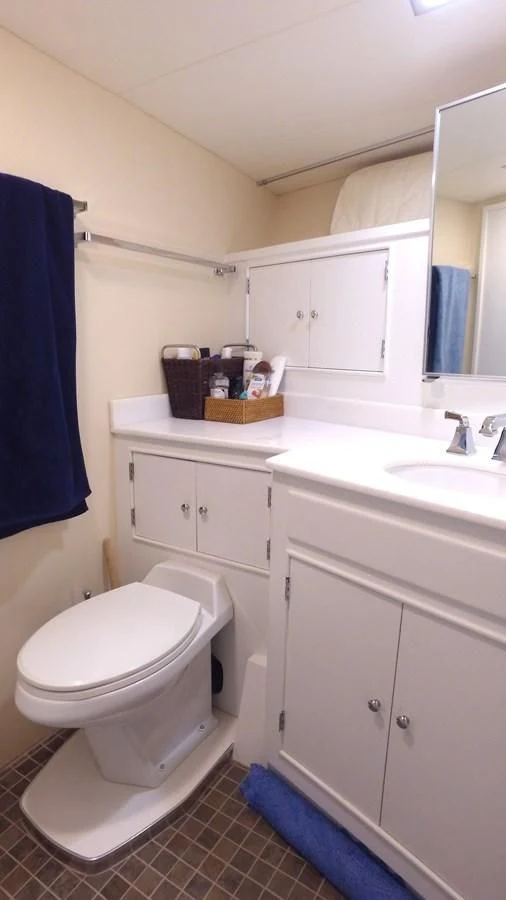 a bathroom with a toilet and sink aboard BAREFOOT V Yacht for Sale