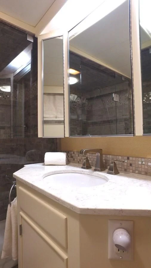a bathroom with a large mirror aboard BAREFOOT V Yacht for Sale