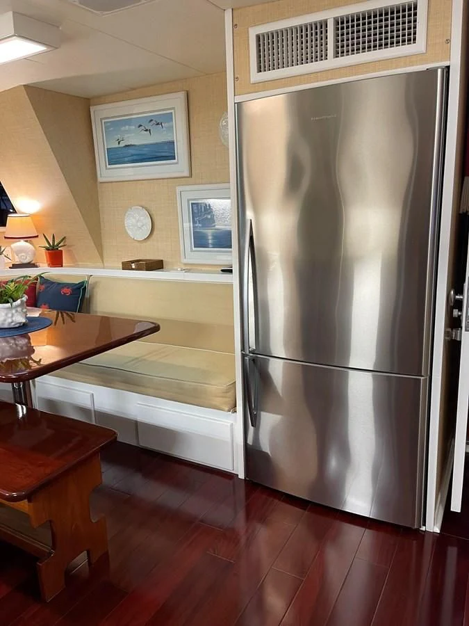 a stainless steel refrigerator in a kitchen aboard BAREFOOT V Yacht for Sale