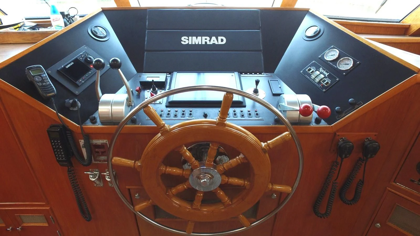 a wooden steering wheel aboard BAREFOOT V Yacht for Sale