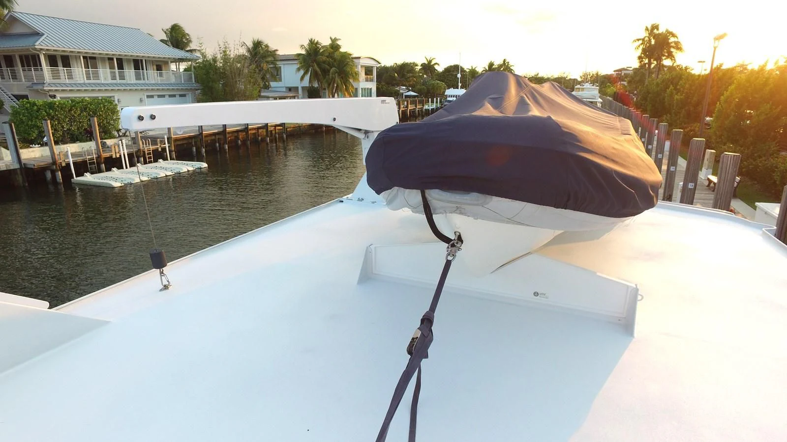 a red and black umbrella on a white table aboard BAREFOOT V Yacht for Sale