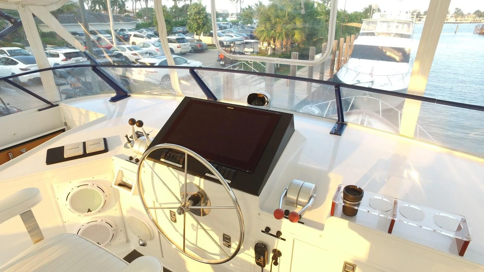 a large white boat with a black screen and a steering wheel aboard BAREFOOT V Yacht for Sale