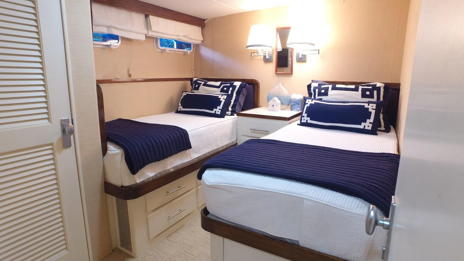 a room with beds and a window aboard BAREFOOT V Yacht for Sale
