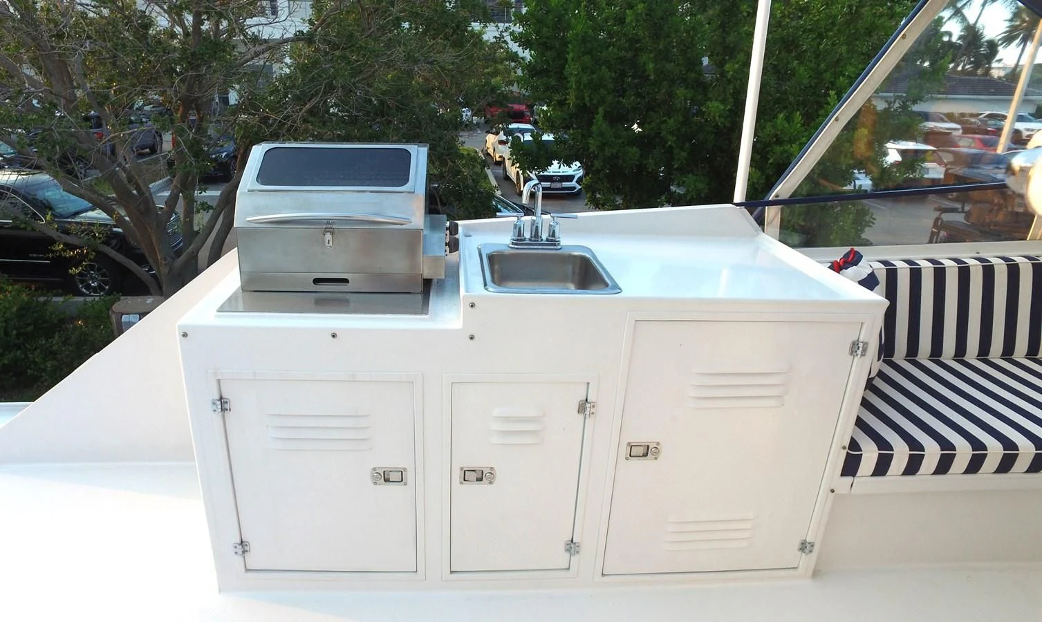a white boat with a deck and a white door on a sunny day aboard BAREFOOT V Yacht for Sale