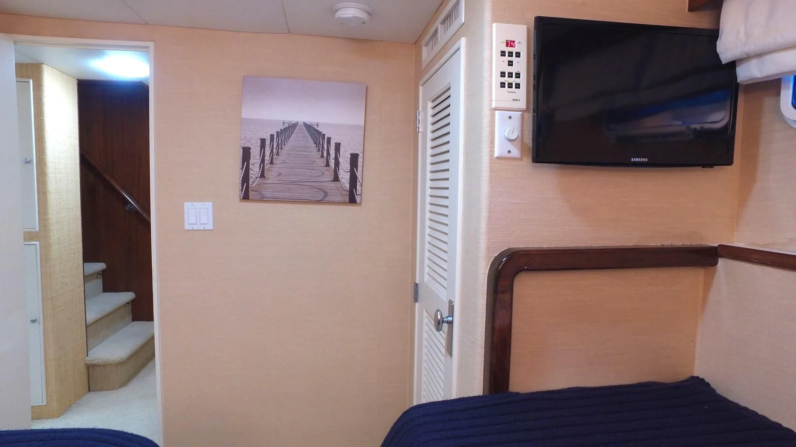 a tv on a wall aboard BAREFOOT V Yacht for Sale