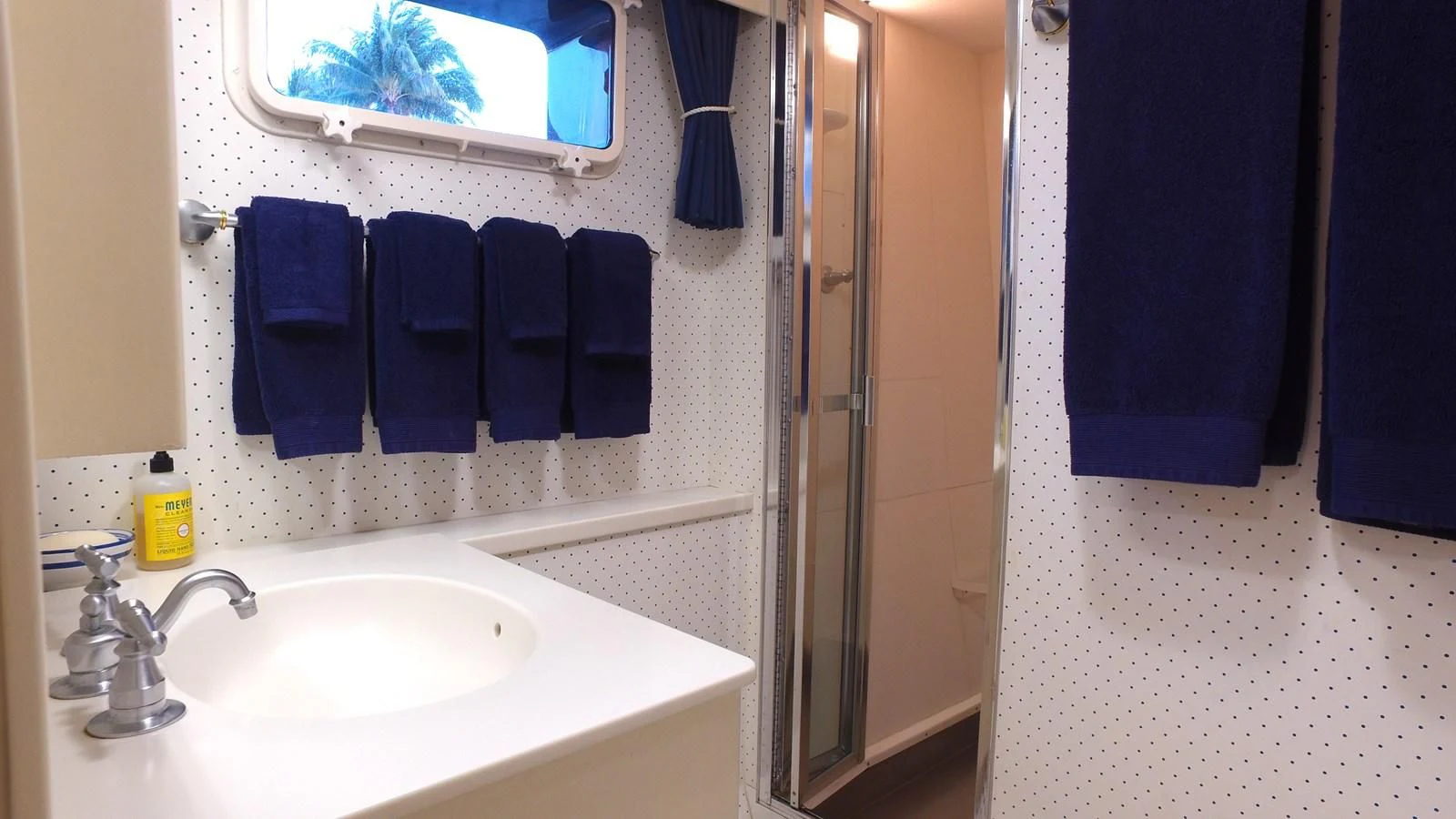 a bathroom with a sink and a mirror aboard BAREFOOT V Yacht for Sale