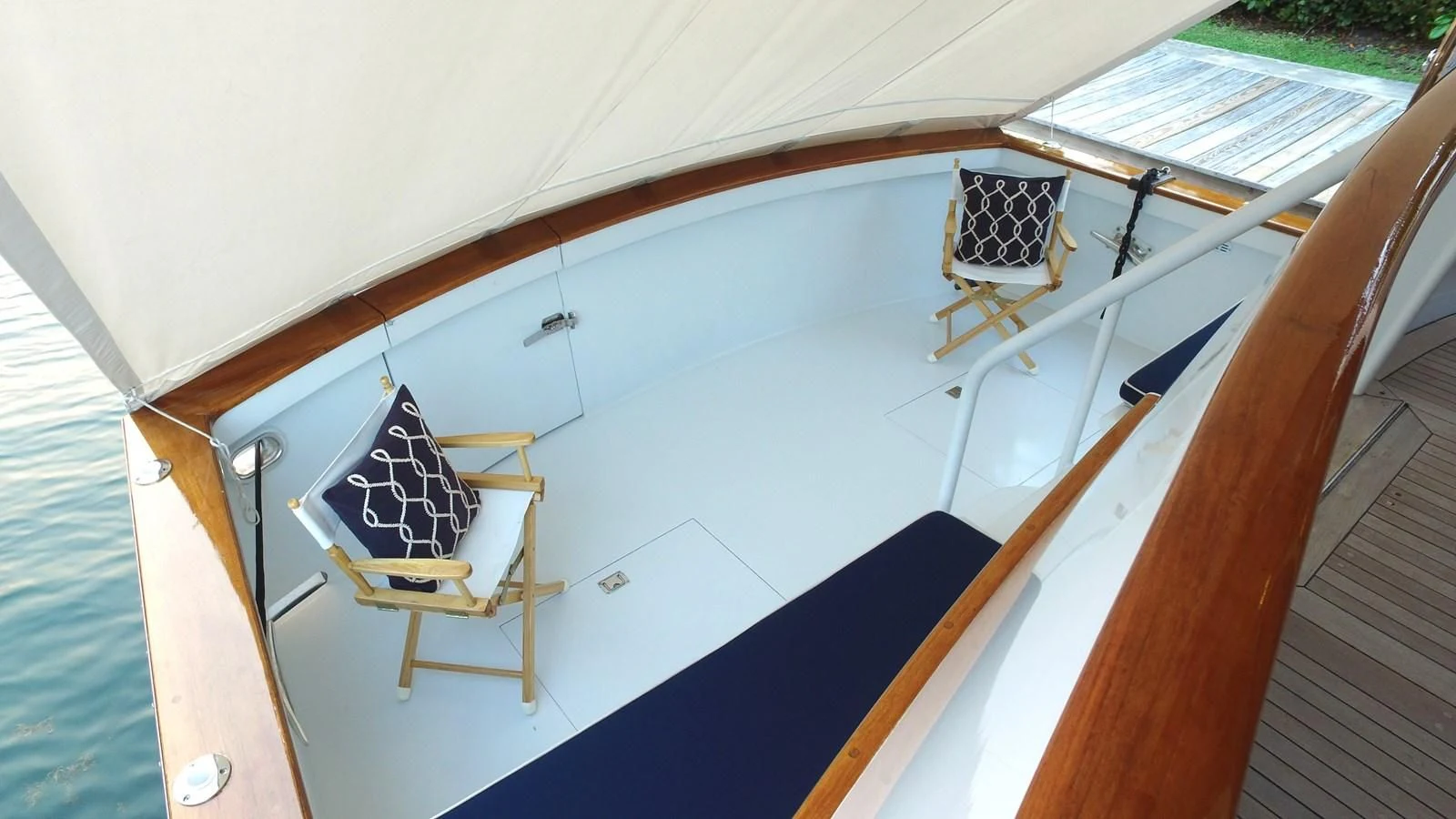 a boat with a flag on the deck aboard BAREFOOT V Yacht for Sale
