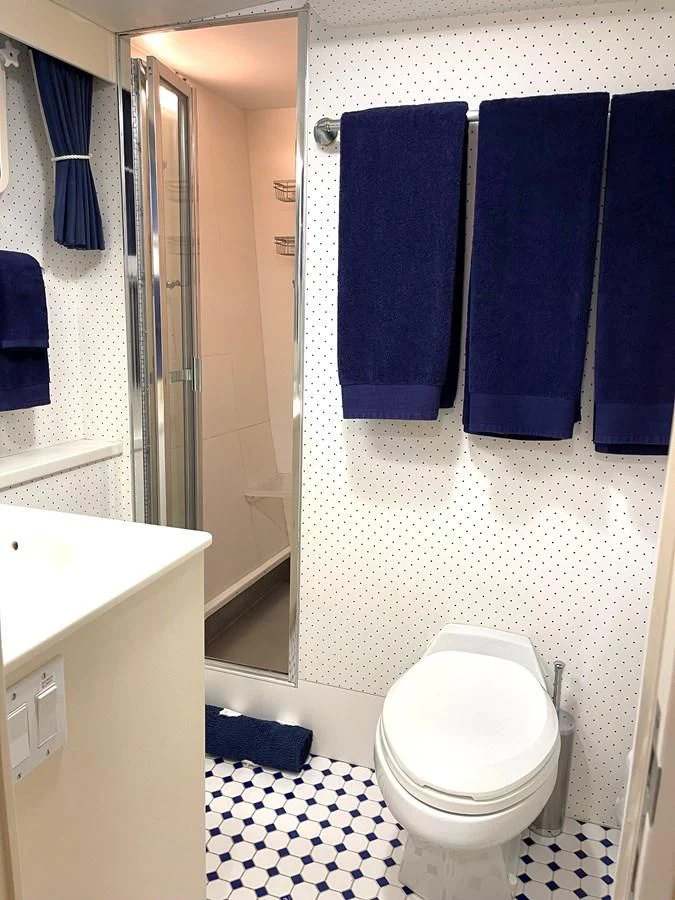 a bathroom with a toilet and a sink aboard BAREFOOT V Yacht for Sale