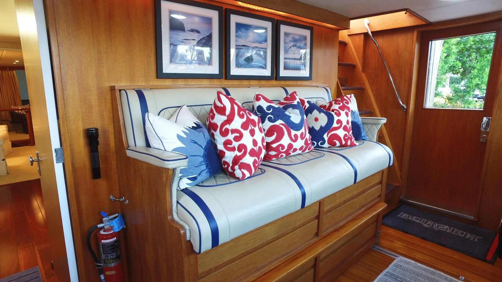 a bed with blue and white pillows aboard BAREFOOT V Yacht for Sale