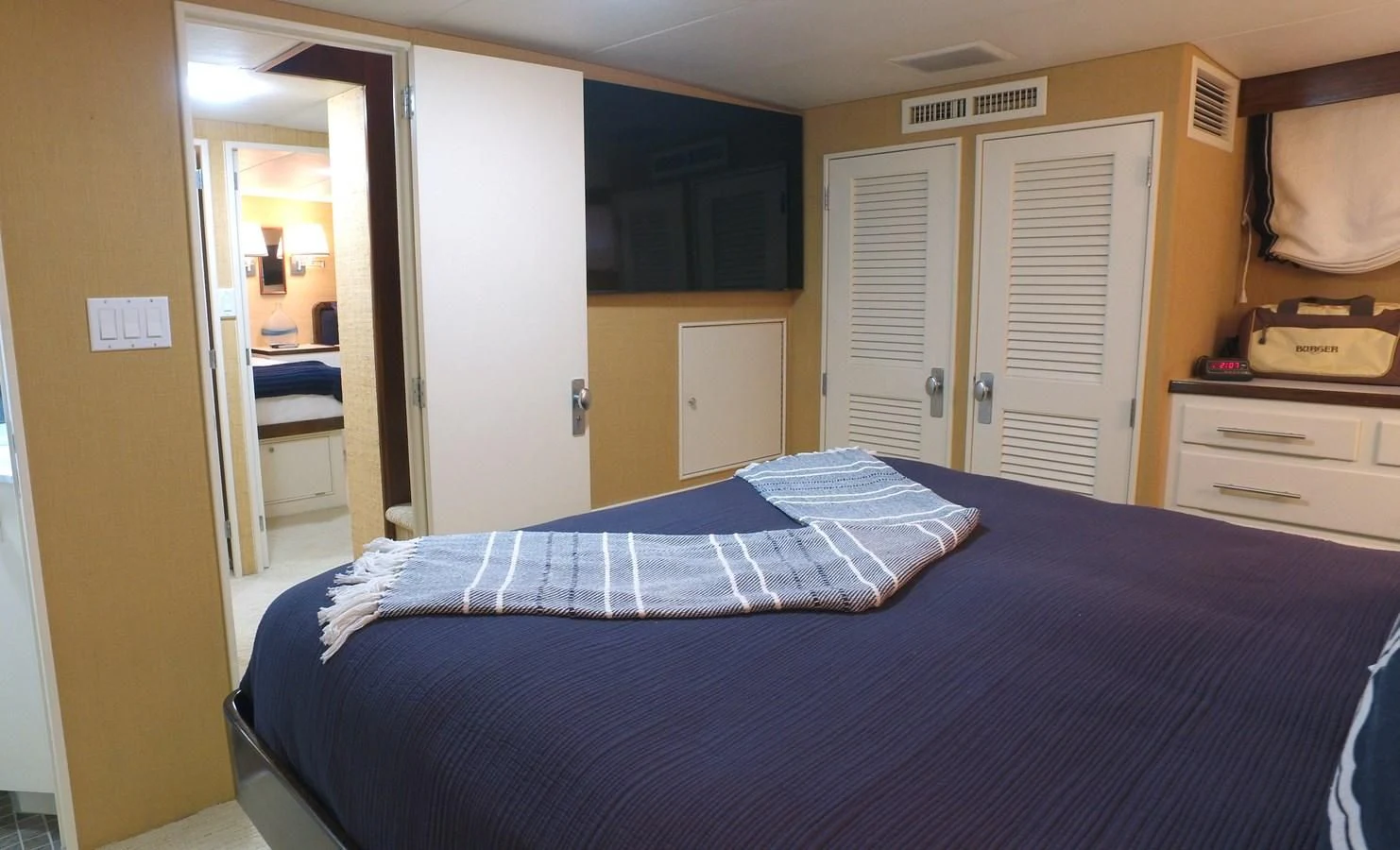 a bedroom with a bed and a closet aboard BAREFOOT V Yacht for Sale